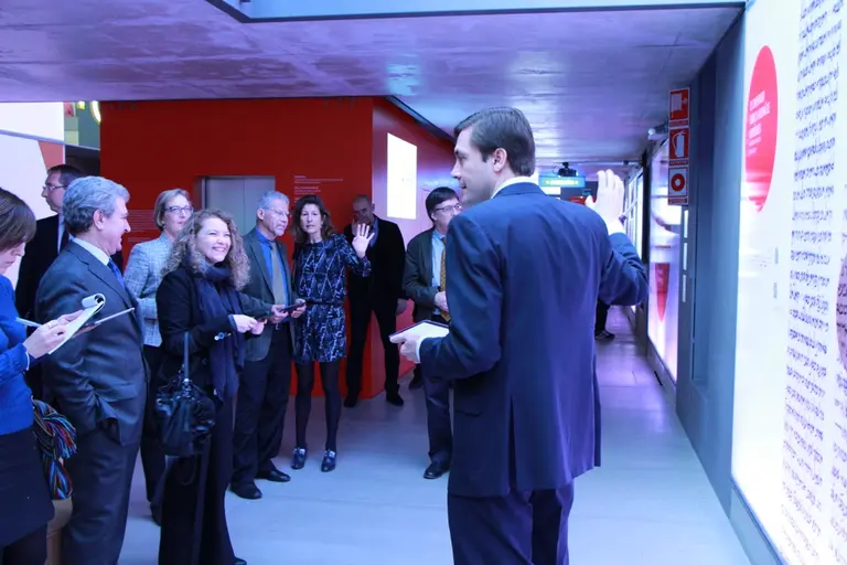 Opening night Event at Casa Del Lector - exhibit goers use a tablet to navigate the complementary material to the exhibit.